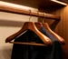 wooden clothes hangers for suits and hotels - polished wooden hangers on a walnut display rack