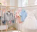 kids clothes hangers - colorful plastic and wooden children's hangers with kids clothing in a bright store